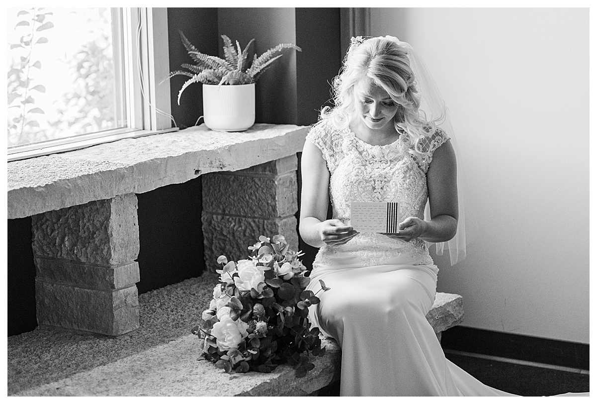 bride reading a letter at a high point church wedding