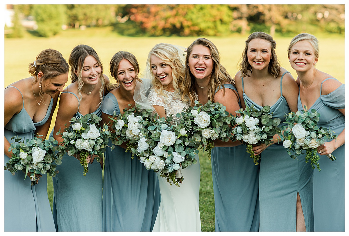 bride and bridesmaids laughing by morgan madeleine photography, wisconsin wedding photographer