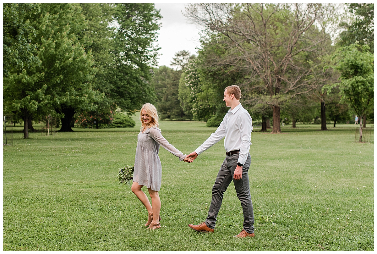 couple walking through the uw arboretum for their madison engagement photos