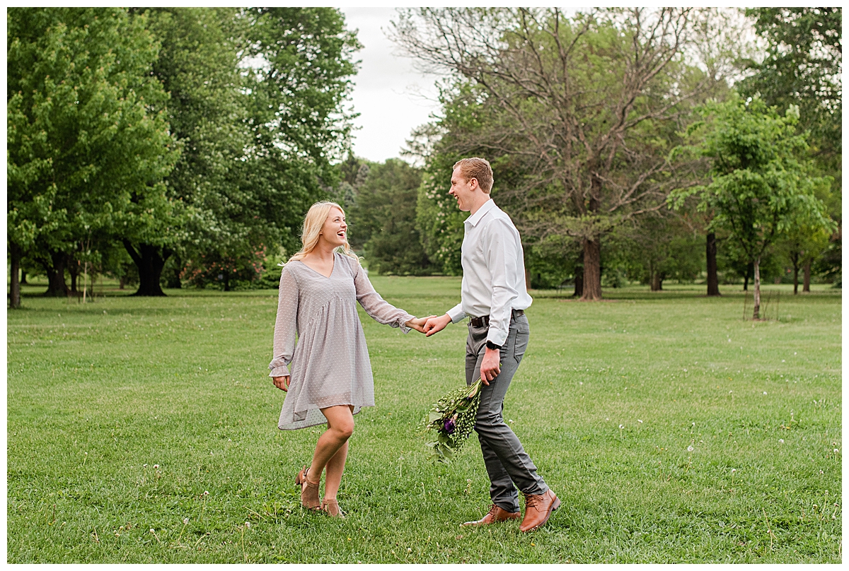 a couple laughing and holding hands at uw arboretum by madison wedding photographer, morgan madeleine photography
