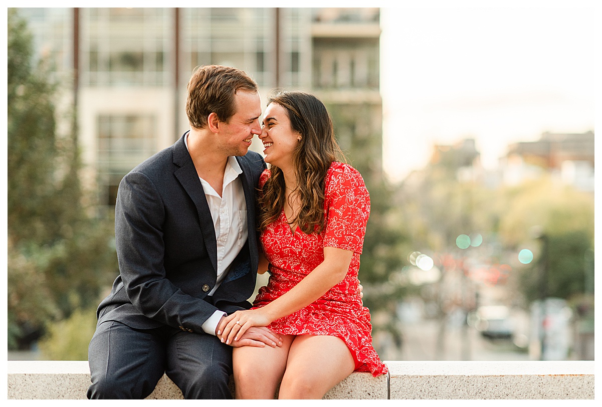 couple taking engagement photos at a madison wedding photography location, the capitol square