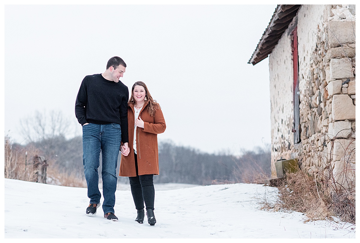 a couple smiling taking wisconsin winter engagement photos
