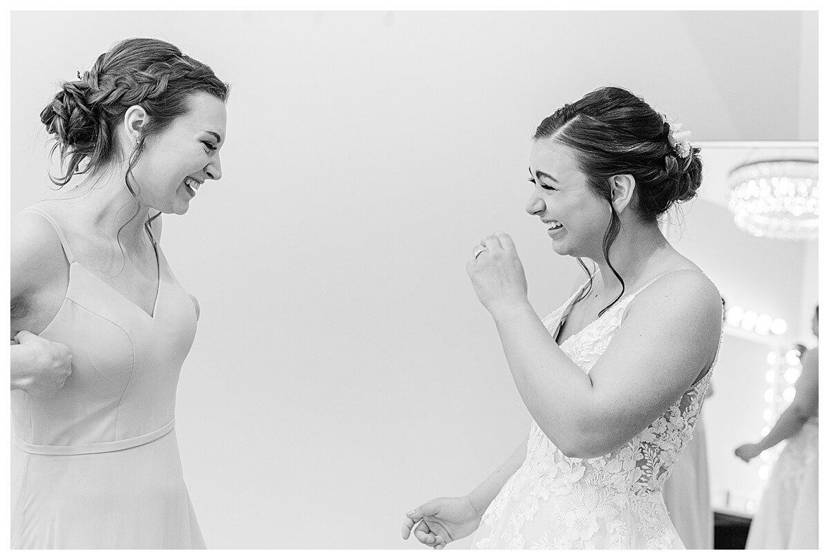 bride laughing with bridesmaid in the getting ready room at the eloise