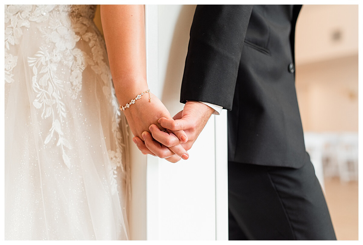 bride and groom holding hands before wedding ceremony at luxury wi wedding venue, the eloise