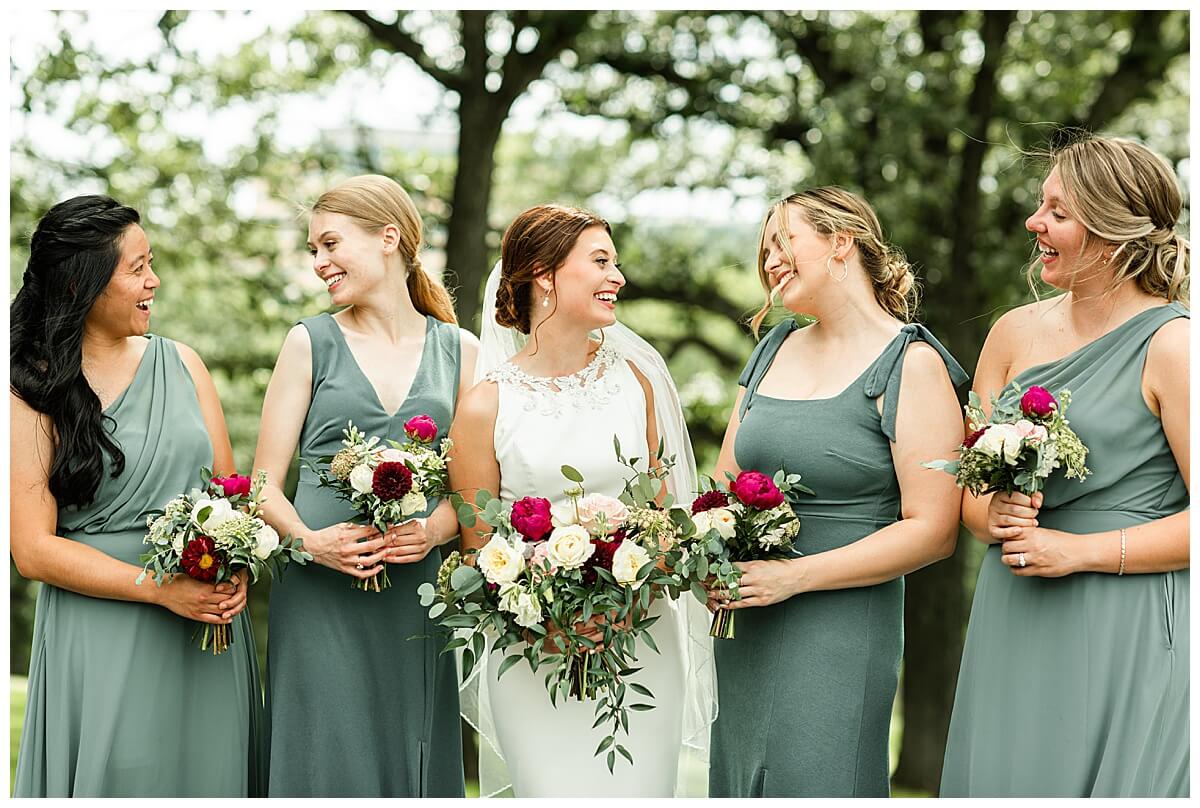 a bride smiling at her bridesmaids at a wedding at blackhawk country club in madison wi