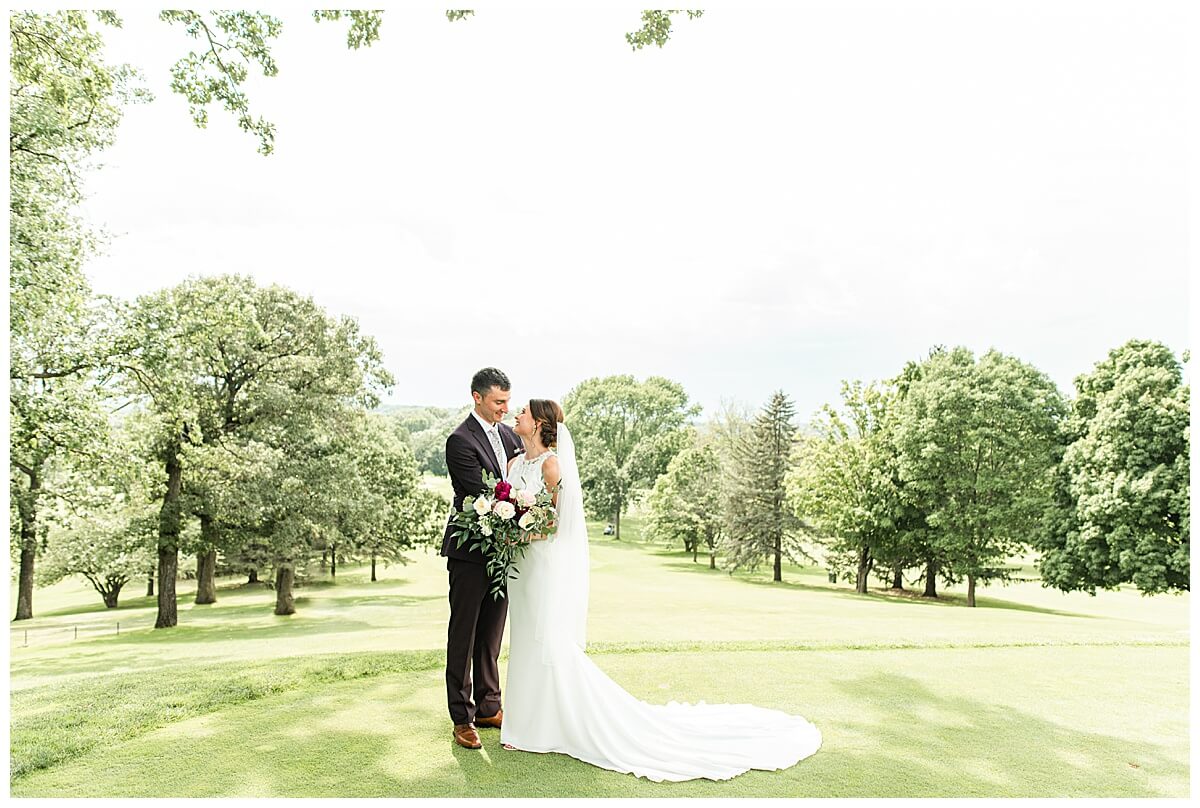 a bride and groom posing for wedding photography in madison wisconsin at a golf course venue