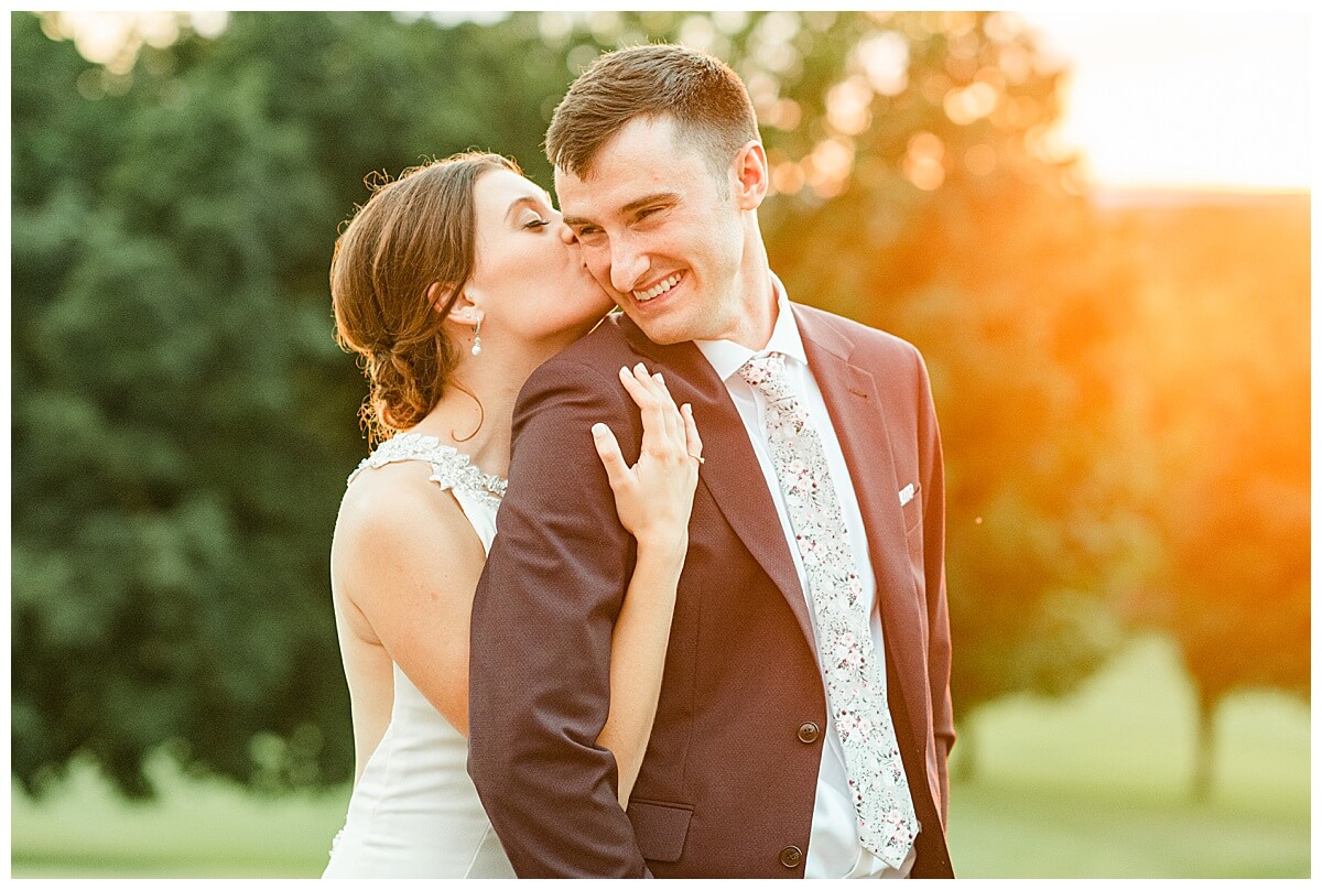 a bride and groom posing during sunset photos at blackhawk country club golf course