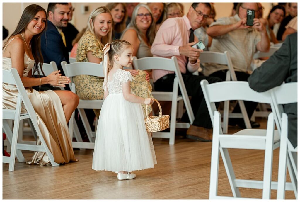 Flower girl walking down the aisle at The Eloise Wedding Venue in Mt Horeb