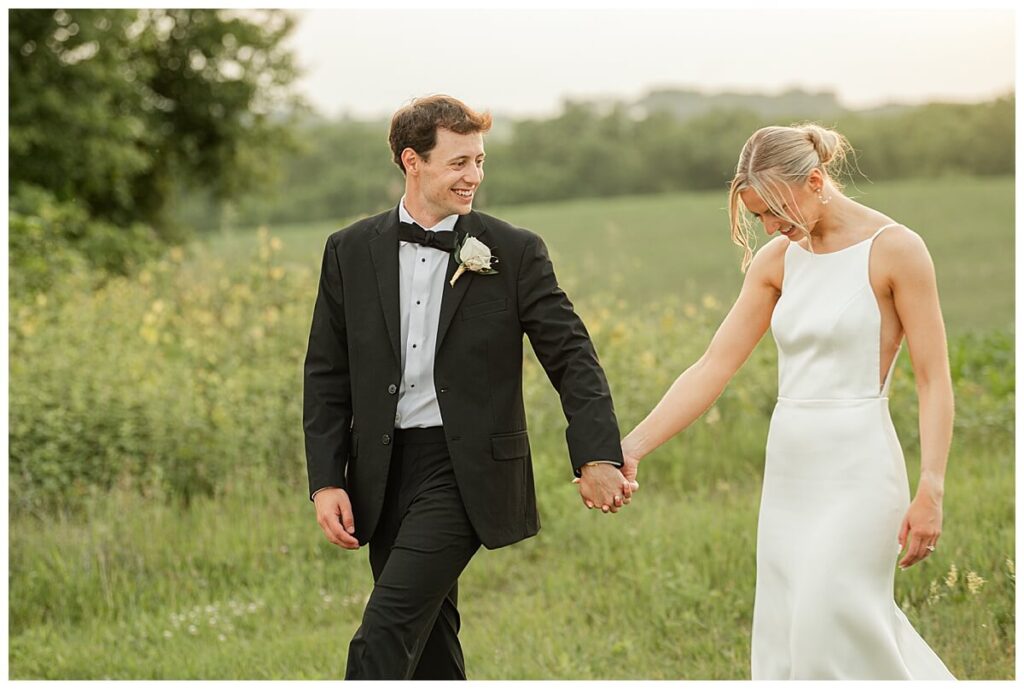 Bride and groom sunset portraits in fields outside The Eloise venue